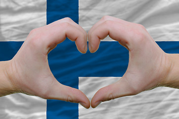 Image showing Heart and love gesture showed by hands over flag of finland back