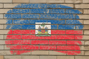 Image showing flag of Haiti on grunge brick wall painted with chalk  
