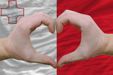 Image showing Heart and love gesture showed by hands over flag of malta backgr