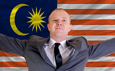 Image showing happy businessman because of profitable investment in malaysia s