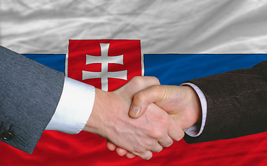 Image showing businessmen handshake after good deal in front of slovakia flag