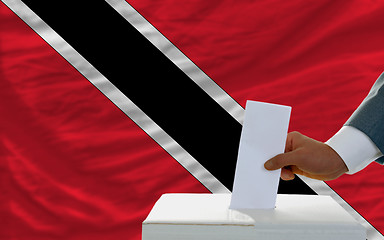 Image showing man voting on elections in trinidad tobago in front of flag