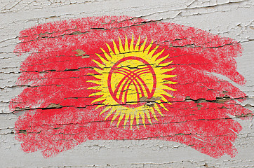 Image showing flag of kyrghyzstan on grunge wooden texture painted with chalk 