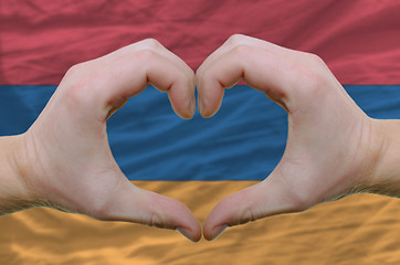 Image showing Heart and love gesture showed by hands over flag of Armenia back