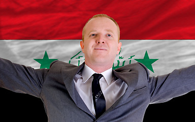 Image showing happy businessman because of profitable investment in iraq stand