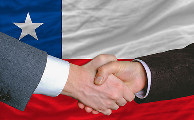 Image showing businessmen handshakeafter good deal in front of chile flag