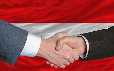 Image showing businessmen handshake after good deal in front of austria flag