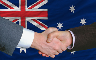 Image showing businessmen handshake after good deal in front of australia flag