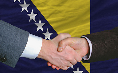 Image showing businessmen handshake after good deal in front of bosnia herzego