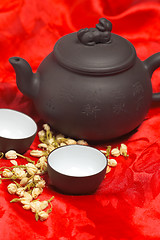 Image showing jasmine tea over red silk