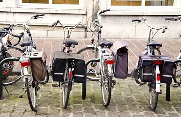 Image showing Bicycles standing in parking place with boxes.