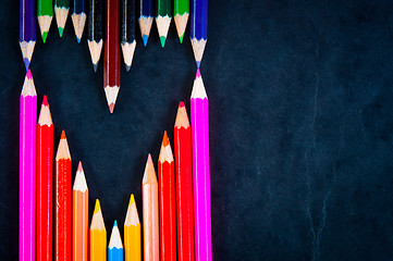 Image showing Colorful pencils on dark background in a shape of a heart