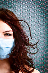 Image showing A girl in a protective mask against white isolated background