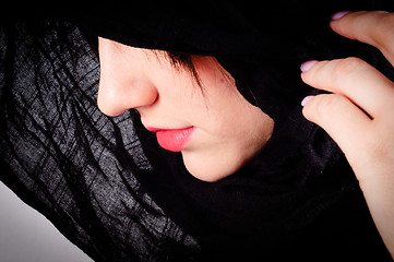 Image showing Part of a woman's face with black hood