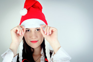 Image showing Girl in Santa's hat against white background