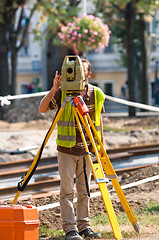 Image showing Worker inspecting site  with his tripod and industrial device