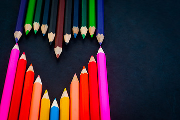 Image showing Colorful pencils on dark background in a shape of a heart