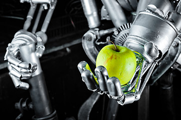 Image showing Green apple in the hands of a robot