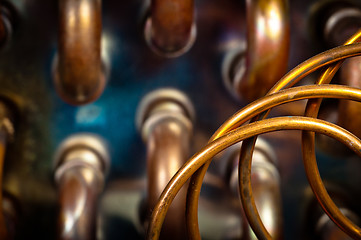 Image showing Orange pipes and hoses with blurry background