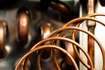 Image showing Close up of orange wires and pipes