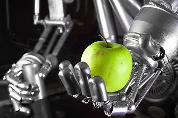 Image showing Robot hand holding green apple