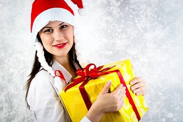 Image showing Young girl with joyful expression holding her present