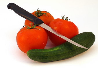 Image showing A knife and fresh vegetables tomato and cucumber