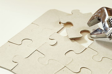 Image showing Solving a puzzle with a tool