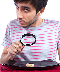 Image showing Man looking to a peanut