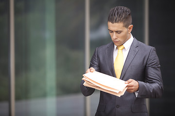 Image showing Businessman walking next to his office