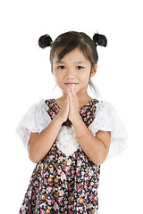 Image showing cute Asian girl with folded hands