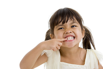 Image showing cute little kid showing her teeth