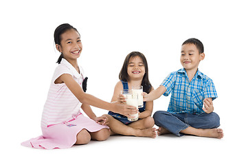 Image showing siblings cheering with milk, isolated on white background