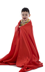 Image showing happy little boy wrapped in red