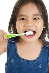 Image showing little asian girl brushing her teeth