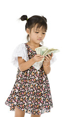 Image showing little girl counting us dollars