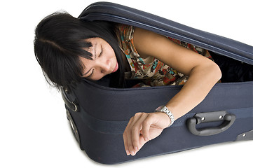 Image showing woman in luggage checking time