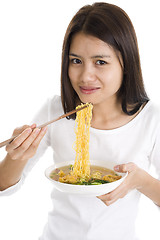 Image showing asian woman eating with chop sticks