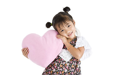 Image showing girl with heart shaped pillow