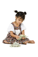 Image showing girl sitting on floor and counting money