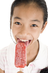 Image showing happy girl licking ice cream