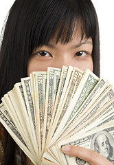 Image showing woman's face behind money