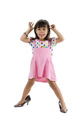 Image showing girl with oversized shoes sticking tongue out