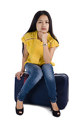 Image showing pretty woman sitting on a bag