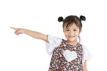 Image showing smiling girl pointing to the side