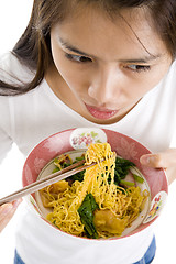 Image showing asian woman eating with chop sticks