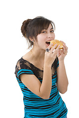 Image showing young woman eating a hamburger