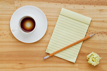 Image showing empty coffee cup and notepad