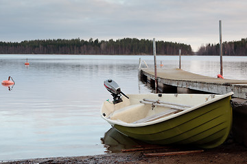Image showing The boat is on the shore of the lake.