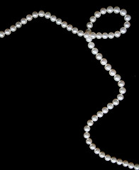 Image showing White pearls on the black velvet  background